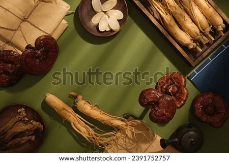 Scene for medicine advertising, photography traditional medicine concept. Some rare herbs displayed on wooden trays on green background. Blank space for presentation product with herbs ingredient