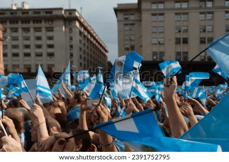 Buenos Aires, Argentina, October 19, 2019. Crowd of people with Argentine flags on the march in support of President Mauricio Macri in Argentina. Royalty-Free Stock Photo #2391752795