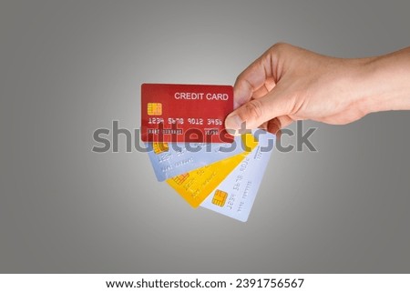 Man holding several credit cards and he use credit card to pay and spend Payment for goods via credit card . Finance and banking concept. Royalty-Free Stock Photo #2391756567