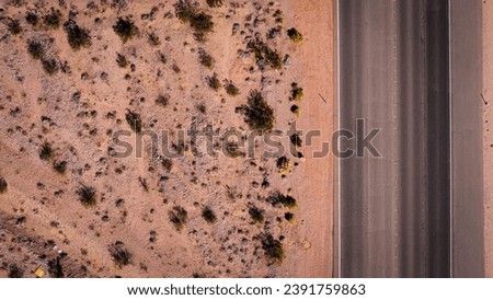 Top down view to a lonesome road through the desert from above aerial view - aerial photography