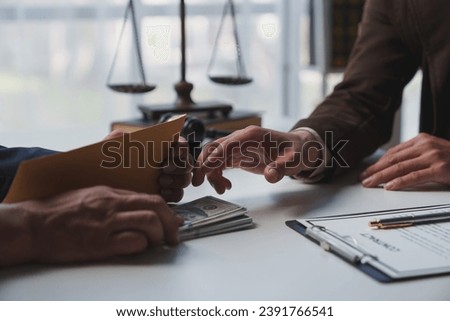 Government tax officials, legal advisers taking bribes of citizens wrapped in brown envelopes. Opening the annual tax evasion, the concept of bribing tax evader officials. Royalty-Free Stock Photo #2391766541