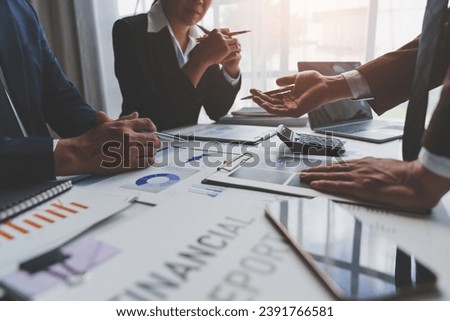 A group of Asian businessmen is meeting to summarize the company's operating results, finances, and profits and losses. Management of startup companies Growing Profitable Management Ideas. Royalty-Free Stock Photo #2391766581
