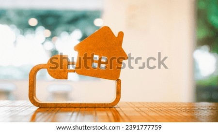 Model house and electricity and plug The concept of crazy electricity consumption and electricity bills. Royalty-Free Stock Photo #2391777759