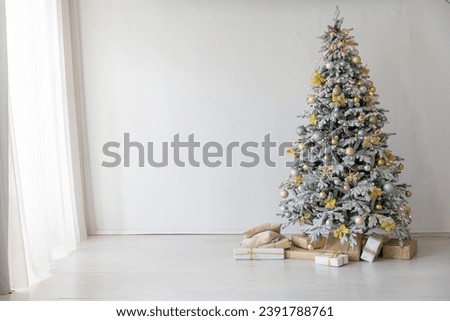 christmas tree with gifts and toys decorated with christmas garland