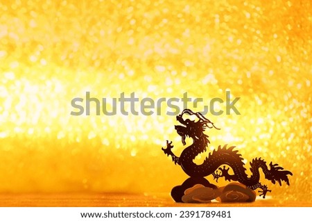 Silhouette of asian dragon on abstract golden glittering background. lunar new year horoscope symbol. Chinese dragon - symbol of deity, wisdom, good start, power. element for design. copy space
