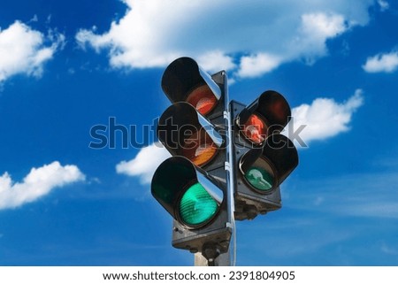 Capturing the essence of urban traffic regulation, this image showcases the essential traffic light system at a bustling city intersection. The red, yellow, and green lights stand as silent sentinels.