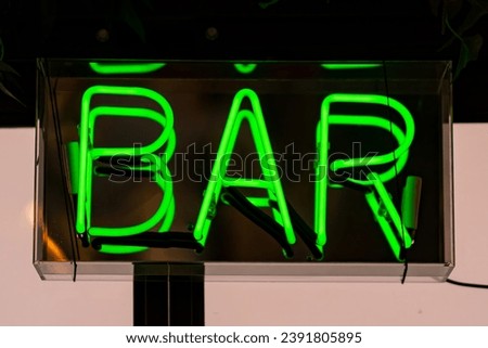Green neon font with the word BAR.