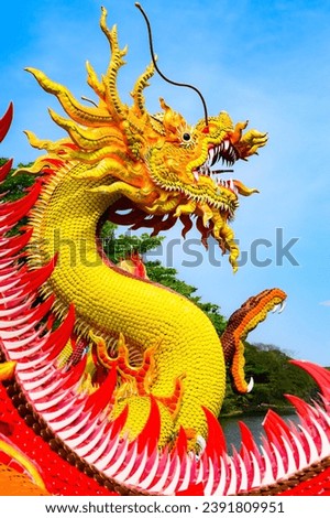 Yellow dragon statue with blue sky, Nakhon Sawan province.