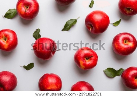 Many red apples on colored background, top view. Autumn pattern with fresh apple above view.