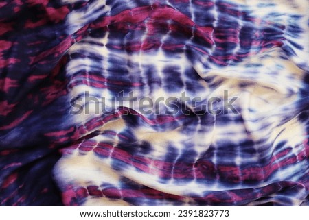 Pink and purple wavy fabric. Abstract background. Draped cotton fabric.