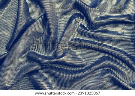 Gray wavy textile with silver glitters. Abstract luxury background. Draped silky fabric.