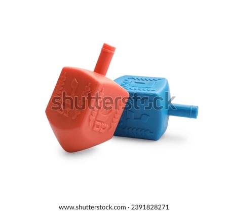 Colorful dreidels isolated on white. Traditional Hanukkah game Royalty-Free Stock Photo #2391828271