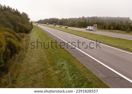 Drone photography of highway in a morning autumn fog during cloudy day