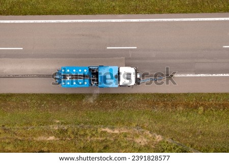 Drone photography of truck removing road signs in a highway during autumn cloudy day