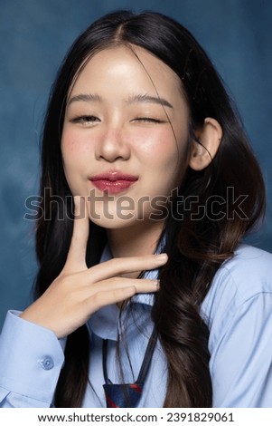 Beautiful Asian woman in school uniform taking a photo of yearbook trend. American yearbook trend popular portrait photography style in Asia. Royalty-Free Stock Photo #2391829061