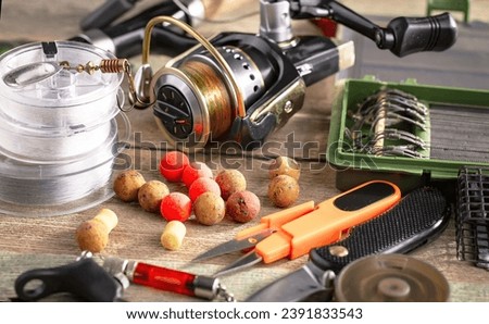 Spinning rods, reels, items for sport fishing, on an old background.