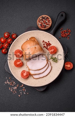 Delicious smoked pork or chicken meat with salt, spices and herbs on a dark concrete background