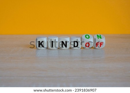 Turned wooden cubes and changes red word Kind off to Kind on. Beautiful orange background. Business and kind on or off concept. Copy space.