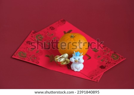 Happy New Year Chinese of the dragon 2024. Mandarin orange, dragon and gold ingot on red envelopes isolated on red background. The word inside picture means blessing.