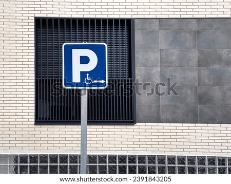 Road sign for the disabled. Disabled parking sign on the asphalt. Parking space with a sign for the disabled.