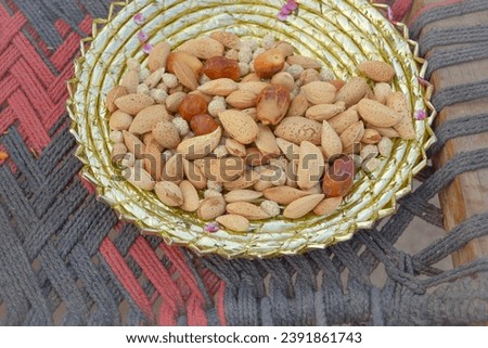Close Up Capture of Mixed Nuts and dried fruits in Pot. top view, banner. Healthy snack - mix of organic nuts and dry fruits. With selective focus on the subject.