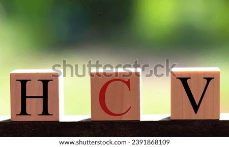 HCV made by wooden dice letters and color crossing for the related meanings of the concept.