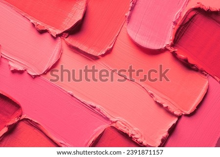 Smudged colorful lipstick pink and peach red background. Cosmetic texture Royalty-Free Stock Photo #2391871157