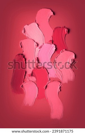 Smudged colorful lipstick pink and peach red background. Cosmetic texture