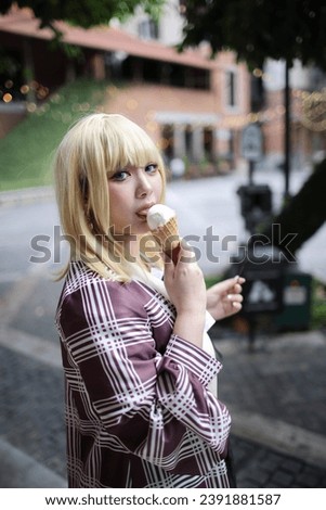 Portrait of a beautiful young woman game Cosplay with blonde hair with ice cream