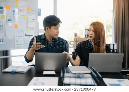 Furious two Asian businesspeople arguing strongly after making a mistake at work in modern office

