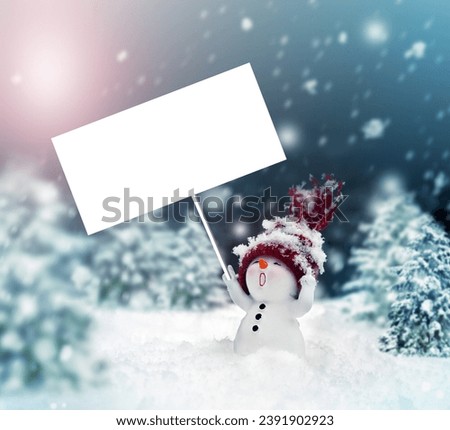 Happy snowman in the winter scenery with the blank advertising banner.