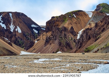  Amazing Iceland - dream for tourists and photographers. Landmannalaugar.  Rhyolite mountains, remains of last year's snow and solidified lava flows.