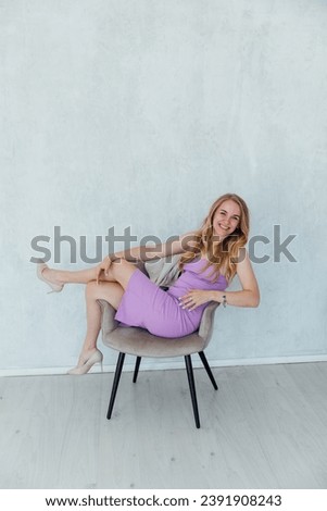 blonde woman in business purple dress in office