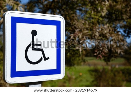 Sign indicating passage for the physically disabled