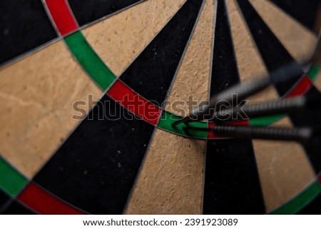 Success hitting target aim goal achievement concept background - three darts in bull's eye close up. Royalty-Free Stock Photo #2391923089