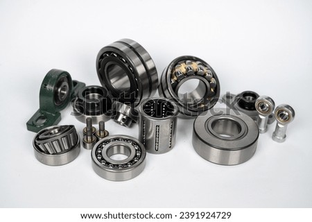 bearings of different types on a white background, ball bearing, roller bearing, pivot head, double-row roller bearing, bearing in housing, conical roller Royalty-Free Stock Photo #2391924729