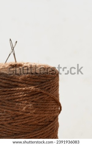 Jute needle roll with white background and space for text.
