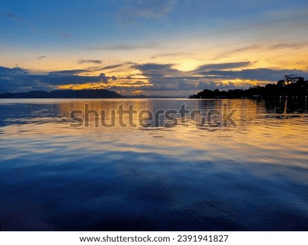 photo of the sunset over a large lake