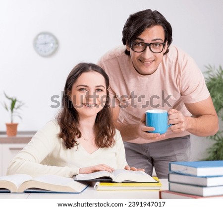 Students preparing for exam together at home Royalty-Free Stock Photo #2391947017