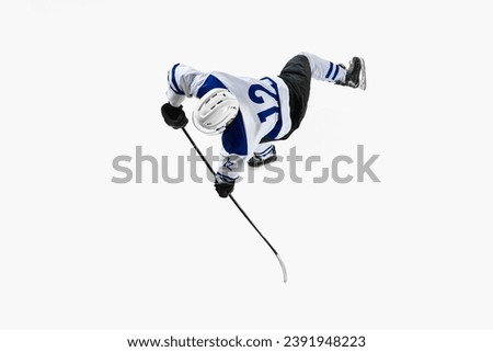 Game on. Top view. Young man, hockey player in motion during game, championship against white studio background. Concept of professional sport, competition, game, tournament, game, action