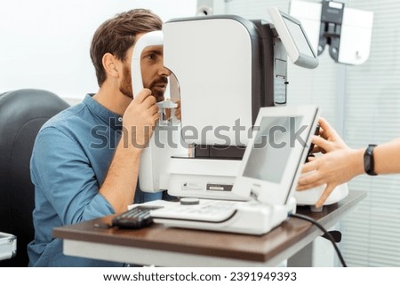Doctor ophthalmologist checking eye vision of man on autorefractor. Health care, medicine, people concept Royalty-Free Stock Photo #2391949393