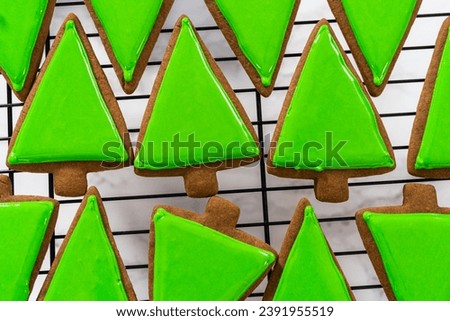 Decorating Christmas gingerbread cookies with royal icing.