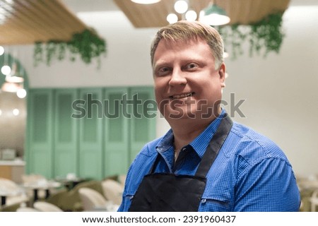 Portrait of a male waiter, blond, 40-44 years old, close-up. Royalty-Free Stock Photo #2391960437