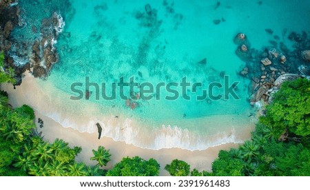 Bird eye drone shot of beautiful white sandy beach, turquoise water and granite stones, Mahe Seychelles 1 Royalty-Free Stock Photo #2391961483