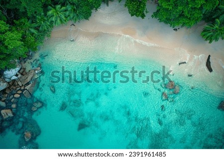 Bird eye drone shot of beautiful white sandy beach, turquoise water and granite stones, Mahe Seychelles 4