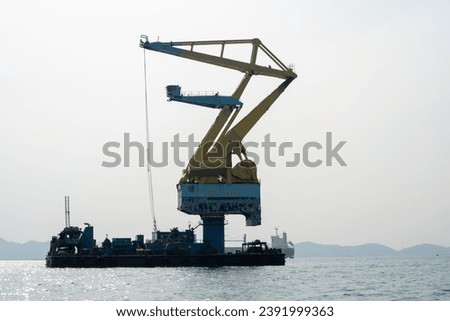 Big Crane Working in Cargo Ship in the Ocean.