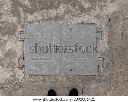 DUBAI ELECTRICITY and  WATER AUTHORITY WATER METER MANHOLE COVERS EN124 B125 by SMITHLINE ,Rusty Water Valve Box Cover Texture top view , Dubai, Al qouz , 23,November 2023