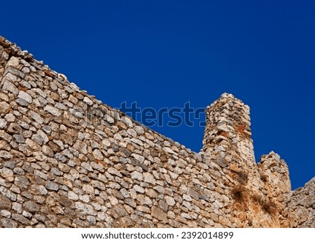 The old fortress wall against the blue sky. Photo of the ruins of the old fortress.