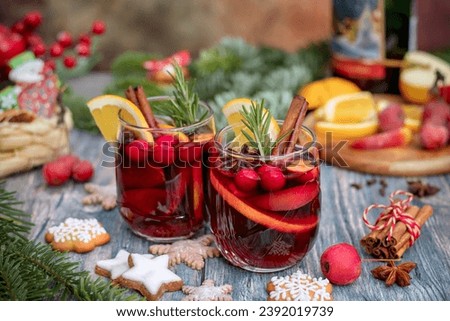 Two glasses of hot mulled wine and cookies on a table with Christmas decor. Close-up. Christmas background.