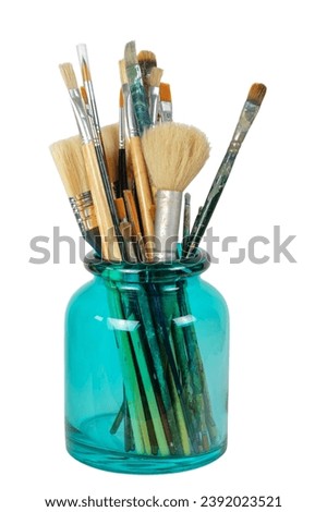 Various professional paint brushes in the green glass jar, isolated on white background Royalty-Free Stock Photo #2392023521